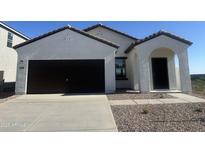 Charming single-story home with a dark-colored garage door and desert landscaping at 15505 W Corte Del Sol Este --, Waddell, AZ 85355