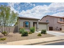 Charming single-story home featuring a well-maintained front yard with desert landscaping and an attached garage at 1630 E Prickly Pear Pl, Casa Grande, AZ 85122