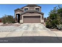 Charming two-story home with a two-car garage and desert landscaping for low maintenance at 23890 W Twilight Trl, Buckeye, AZ 85326