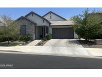 Charming single-story home featuring stone accents, a neutral color palette, and a well-manicured front yard at 26943 N 74Th Ave, Peoria, AZ 85383