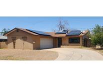 Charming single-story home with solar panels and a two-car garage at 3208 W Port Royale Ln, Phoenix, AZ 85053