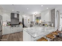 Bright kitchen features marble countertops, stainless steel appliances, and white cabinetry at 4117 E Coolidge St, Phoenix, AZ 85018
