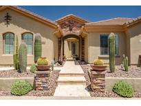 Inviting front entrance with desert landscaping, stone accents, and tiled walkway leading to the front door at 41809 N La Crosse Trl, Anthem, AZ 85086