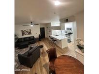 Inviting living room with modern furnishings, an open layout, and light wood-look floors at 5345 E Van Buren St # 216, Phoenix, AZ 85008