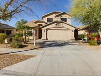Well-maintained two-story home with a two-car garage, manicured landscaping, and a paved driveway at 8022 S 48Th Dr Dr, Laveen, AZ 85339