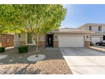 Charming single-story home showcasing a well-manicured front yard and a two-car garage at 8828 N 102Nd Ln, Peoria, AZ 85345