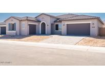 Charming single-story home featuring a tile roof, neutral stucco exterior and a spacious three-car garage at 10013 S 36Th Ave, Laveen, AZ 85339