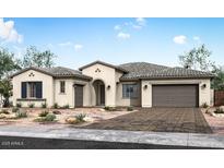 Stunning single-story home showcasing a tile roof, desert landscaping, and an arched entryway at 10013 S 36Th Ave, Laveen, AZ 85339