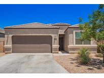 Charming single-story home featuring a two-car garage and xeriscaped front yard with a beautiful, desert tree at 1254 E Thomas Dr, Casa Grande, AZ 85122