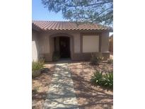 Charming single-story home with desert landscaping and covered entryway at 14938 W Mauna Loa Ln, Surprise, AZ 85379