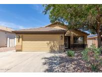 Single Gathering home featuring a two-car garage, desert landscaping, and a neutral color scheme, perfect for curb appeal at 16441 N 138Th Ave, Surprise, AZ 85374