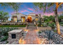 Inviting facade with a landscaped entrance, terracotta tiled roof, and an arched entry at 19054 N 97Th Pl, Scottsdale, AZ 85255