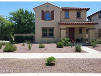 Charming two-story home featuring stucco siding, a red tile roof, and desert landscaping at 21013 W Wycliff Dr, Buckeye, AZ 85396