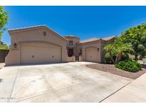 Stunning single-story home with well-manicured landscaping, three-car garage, and inviting curb appeal at 21275 E Russet Rd, Queen Creek, AZ 85142