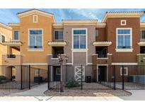 Charming townhouse exterior showcasing a gated entrance and colorful facade, offering inviting curb appeal at 22125 N 29Th Ave # 158, Phoenix, AZ 85027