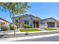 Charming single-story home with manicured lawn, stone accents, and inviting front porch at 3118 E Gary Way, Phoenix, AZ 85042