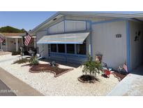 Charming home featuring lovely landscaping, decorative rock, and patriotic decorations for a warm welcome at 3330 E Main St # 430, Mesa, AZ 85213