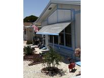 Charming home exterior with decorative landscaping and shaded awning over the windows at 3330 E Main St # 430, Mesa, AZ 85213