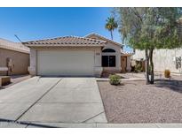 Charming single-story home with a well-manicured lawn, two car garage, and desert landscaping at 363 W Bruce Ave, Gilbert, AZ 85233