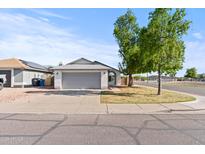 Charming single-story home with a well-manicured lawn and an attached two-car garage at 3651 W Escuda Dr, Glendale, AZ 85308