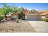 Charming single-story home featuring desert landscaping, a two-car garage, and a welcoming front entrance at 4131 E Cascalote Dr, Cave Creek, AZ 85331