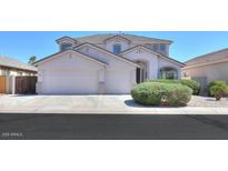 Charming two-story home with well-manicured landscaping and a spacious three-car garage at 43561 W Snow Dr, Maricopa, AZ 85138