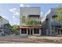 Modern multi-story commercial building with a charming red and white striped awning at 610 E Roosevelt St # 145, Phoenix, AZ 85004