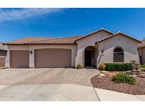 Charming single-story home with a tile roof, three-car garage, arched entry, and landscaped front yard at 682 W Gum Tree Ave, Queen Creek, AZ 85140