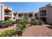 Lovely desert landscaping complements this building's elevated walkways with an orange patio umbrella in the background at 9151 W Greenway Rd # 162, Peoria, AZ 85381