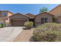 Charming single-story home featuring a two-car garage and low-maintenance desert landscaping at 10009 W Raymond St, Tolleson, AZ 85353