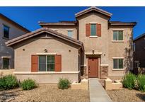 Inviting two-story home with a well-maintained front yard and charming desert landscaping at 10370 W Sands Dr # 463, Peoria, AZ 85383