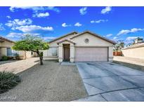 Charming single-story home featuring a low-maintenance desert landscape and a two-car garage at 4144 N 109Th Ave, Phoenix, AZ 85037