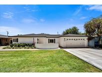Charming single-story home featuring a well-maintained lawn, white brick, and an attached two-car garage at 4243 E Avalon Dr, Phoenix, AZ 85018