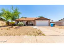 Charming single story home with a large front yard and attached two car garage at 4845 W Sweetwater Ave, Glendale, AZ 85304