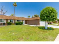 Charming home featuring a well-maintained lawn and mature landscaping in a desirable neighborhood at 10022 W Mountain View Rd, Sun City, AZ 85351