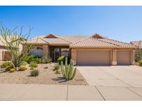 Charming single-story home with a well-manicured desert landscape and a three-car garage at 11103 E Blue Sky Dr, Scottsdale, AZ 85262