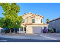 Charming two-story home with a well-manicured front yard and a two-car garage in a sunny neighborhood at 1723 E Pontiac Dr, Phoenix, AZ 85024