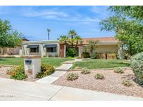 Inviting single-story home with manicured lawn, desert landscaping, and a picturesque walkway at 2236 E Sierra St, Phoenix, AZ 85028
