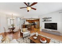 Bright living room featuring hardwood floors, modern decor, and an open floor plan to the kitchen and dining area at 2401 E Rio Salado Pkwy # 1047, Tempe, AZ 85288