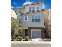 Modern two-story home with neutral siding, brick accents, a gray garage door, and well-maintained landscaping at 663 W Flintlock Way, Chandler, AZ 85286