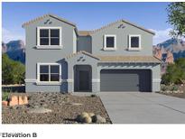 Charming two-story home showcasing a desert landscape, a two-car garage, and a stylish gray facade at 9932 S Desert View Dr, Apache Junction, AZ 85120