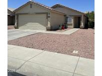 Charming single-story home with a two-car garage, low-maintenance desert landscaping, and covered entrance at 12138 W Flores Dr, El Mirage, AZ 85335