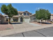 Charming two-story home with a well-maintained front yard and desert landscaping at 15040 W Windrose Dr, Surprise, AZ 85379