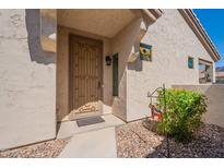 Inviting front door with decorative security screen and desert landscaping at 1552 E Manor Dr, Casa Grande, AZ 85122
