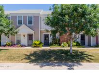 Charming townhome with well-maintained lawn and landscaping, providing inviting curb appeal at 1600 N Saba St # 151, Chandler, AZ 85225