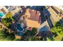 Expansive aerial view of a private residence with a spacious backyard, sparkling pool, and lush landscaping at 2004 N 125Th Ave, Avondale, AZ 85392
