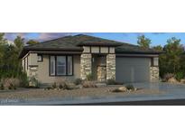 Charming single-story home featuring stone accents, desert landscaping, and a two-car garage at 20739 E Arroyo Verde Dr, Queen Creek, AZ 85142
