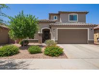 Charming two-story home features a well-manicured lawn, desert landscaping, and a spacious two car garage at 25546 N 164Th Dr, Surprise, AZ 85387