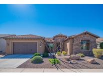 Charming desert home featuring a stone facade, desert landscaping, and a two-car garage at 26333 W Vista North Dr, Buckeye, AZ 85396