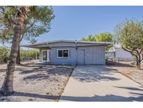 Charming single-story home featuring desert landscaping and a long private driveway at 2853 W Ohio St, Apache Junction, AZ 85120